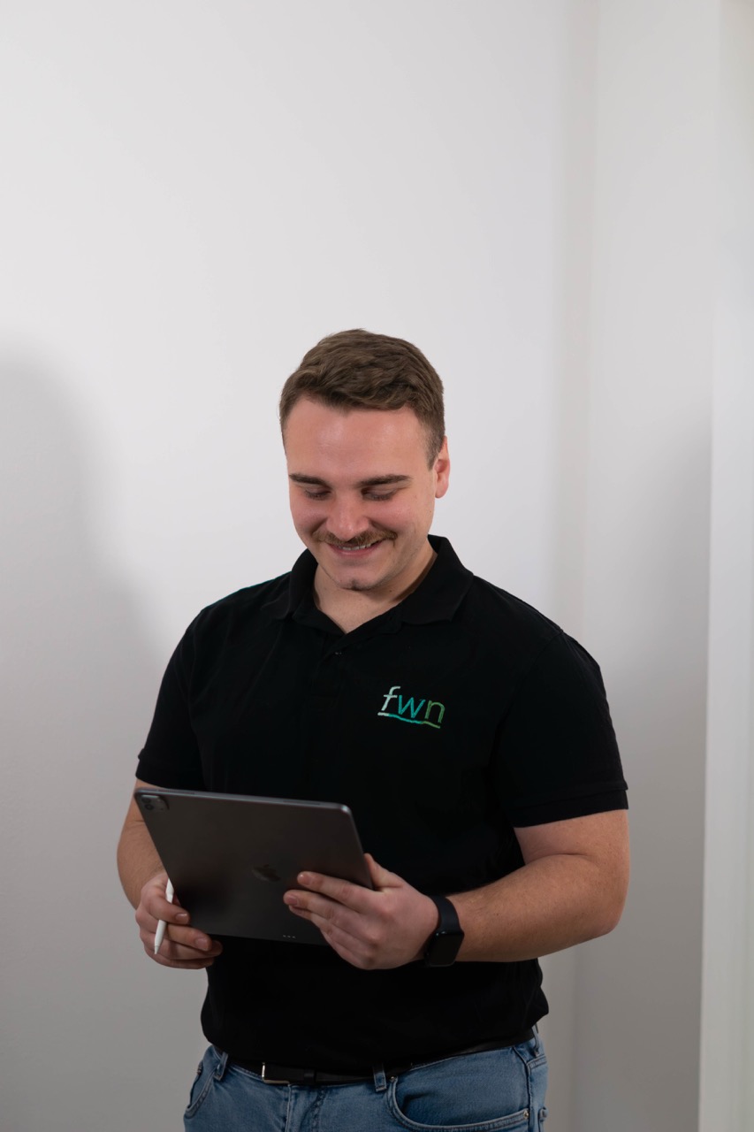 Webdesigner prüft ein Kontaktformular auf dem Tablet